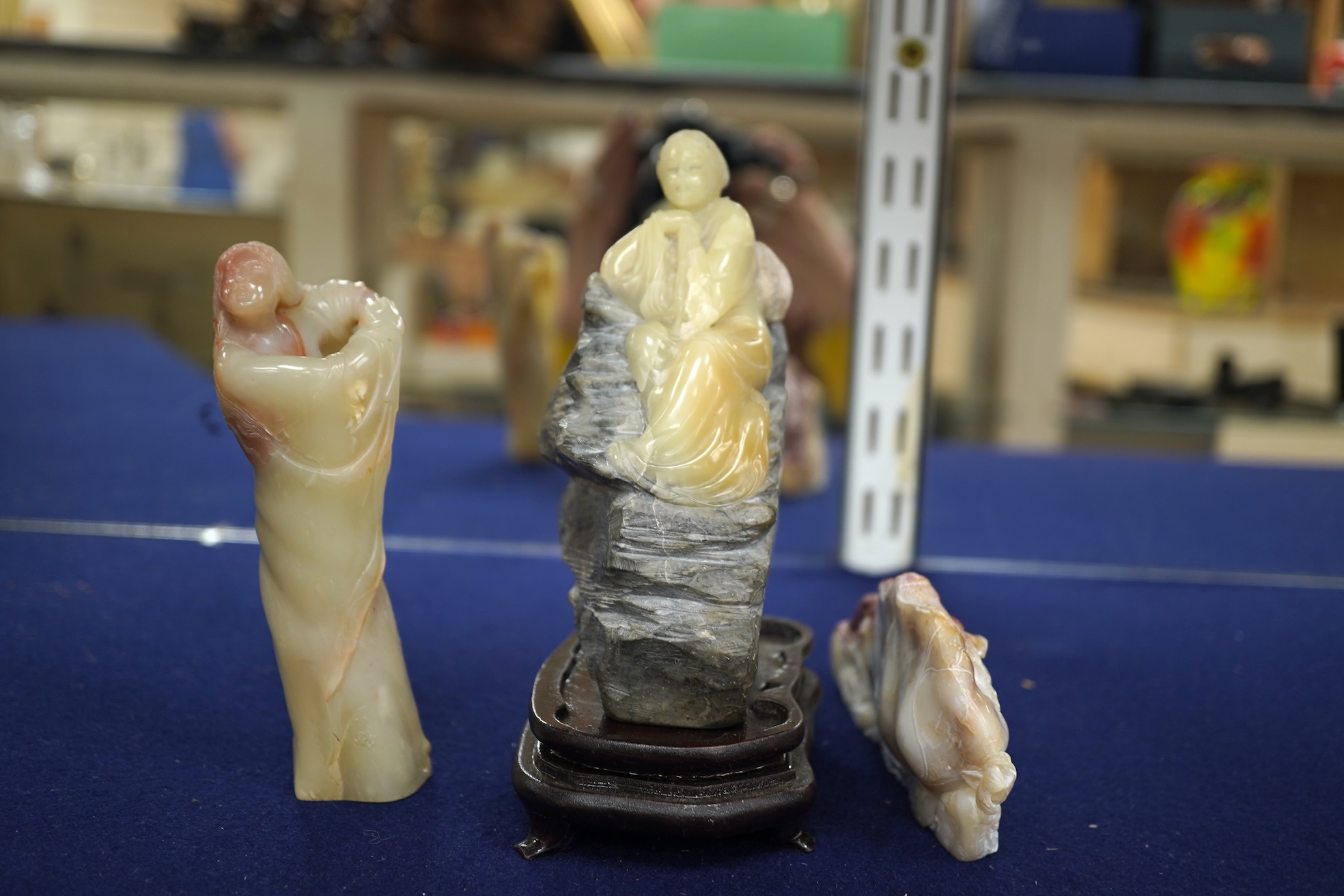 Three Chinese Shoushan stone figures of ladies and an associated stand, tallest 14cm